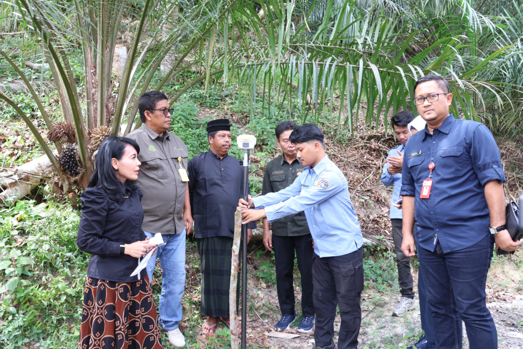 Staf Khusus Menteri Bidang Reforma Agraria Kementerian ATR/BPN, Rezka Oktoberia (kiri) saat menyaksikan prosesi pengukuran tanah ulayat di Desa Gunung Sahilan, Kabupaten Kampar, Kamis, 9 Juli 2026.